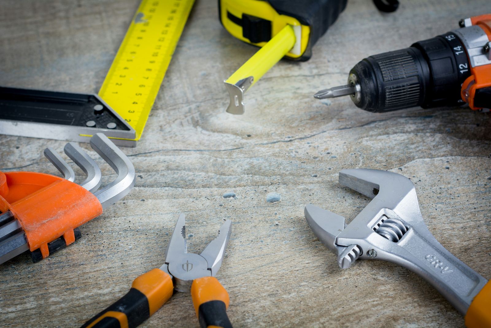 Hand tools and measuring equipment arranged on a contractor workbench
